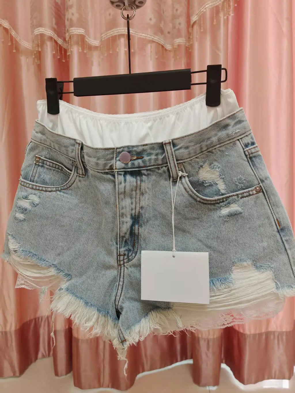 Fake two-piece lace-lined ripped denim shorts