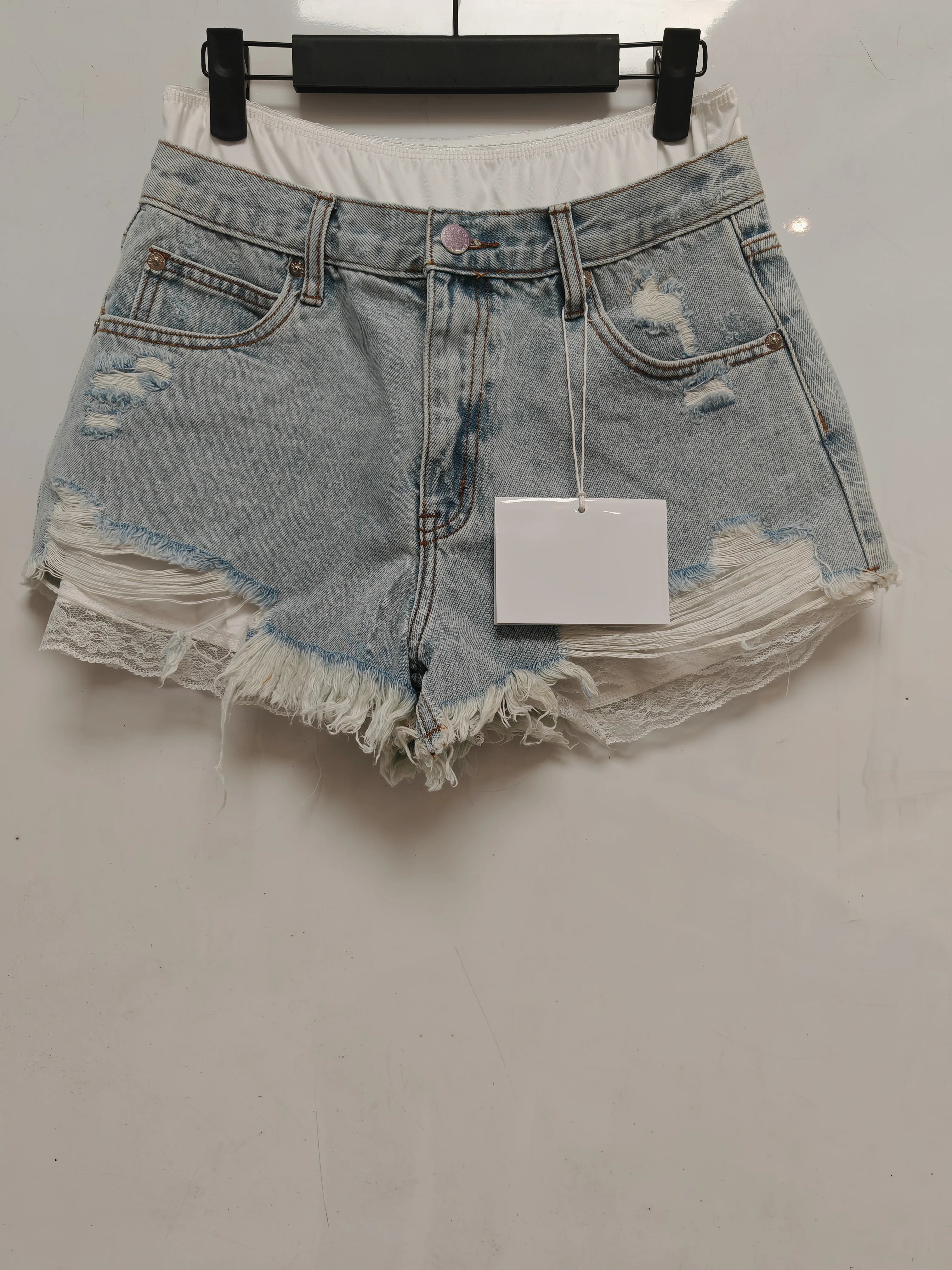 Fake two-piece lace-lined ripped denim shorts